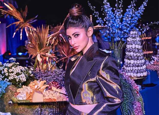 Mouni Roy dazzles in a stunning golden dress at Hyderabad fashion event.